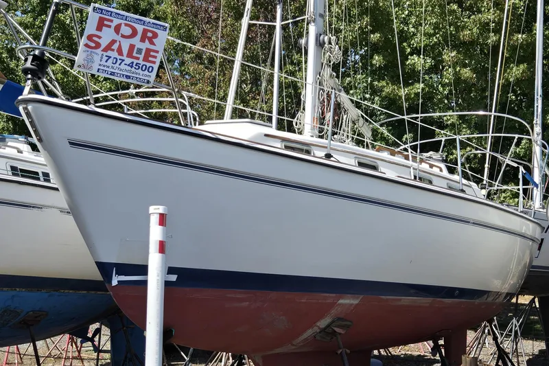 Slide: The Image of 1986 Pearson 303 Sloop sailboat for sale, displayed on land with a "For Sale" sign. - 28