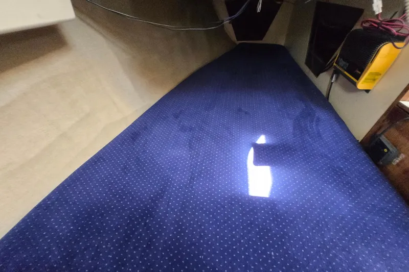 Slide: The Image of Interior cabin of 1986 Pearson 303 Sloop with blue polka dot bedding. - 13