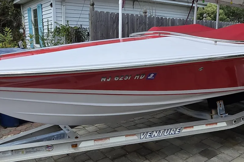 The Image of 2005 Donzi 16 Classic boat with red and white hull on a trailer. - 0