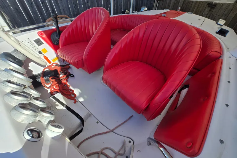 Slide: The Image of 2005 Donzi 16 Classic boat interior with red leather seats and dashboard controls. - 2