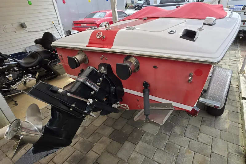 Slide: The Image of 2005 Donzi 16 Classic boat with red and white design, featuring a MerCruiser engine. - 8