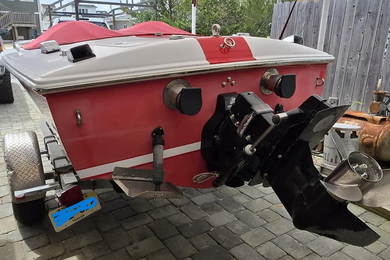 Slide: The Image of 2005 Donzi 16 Classic boat on trailer, red and white design, rear view. - 9