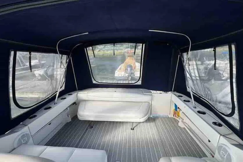Slide: The Image of 2005 Sea Ray 290 Amberjack interior with seating and windows, featuring a spacious cabin layout. - 10