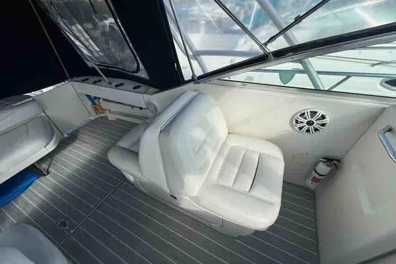 Slide: The Image of 2005 Sea Ray 290 Amberjack interior with white seating and modern design. - 12