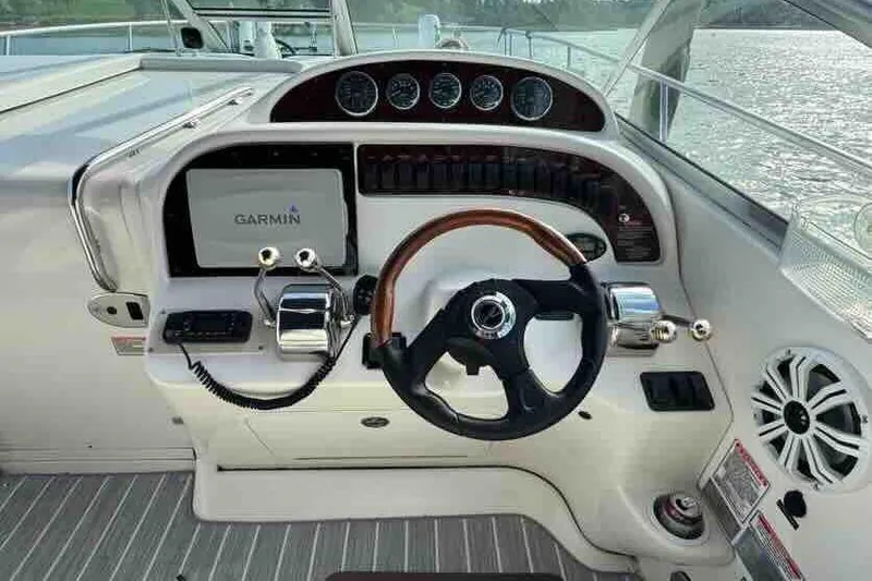 Slide: The Image of 2005 Sea Ray 290 Amberjack helm with Garmin display and steering wheel. - 13