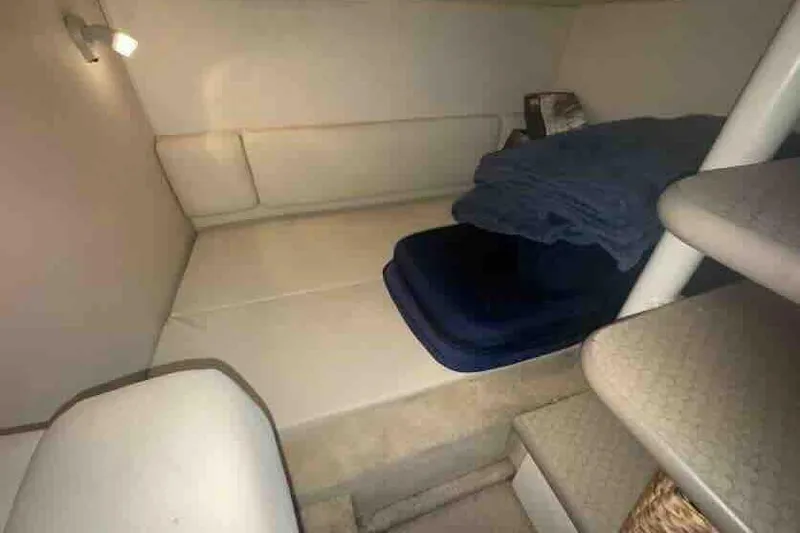 Slide: The Image of 2005 Sea Ray 290 Amberjack cabin interior with bed and stairs. - 20