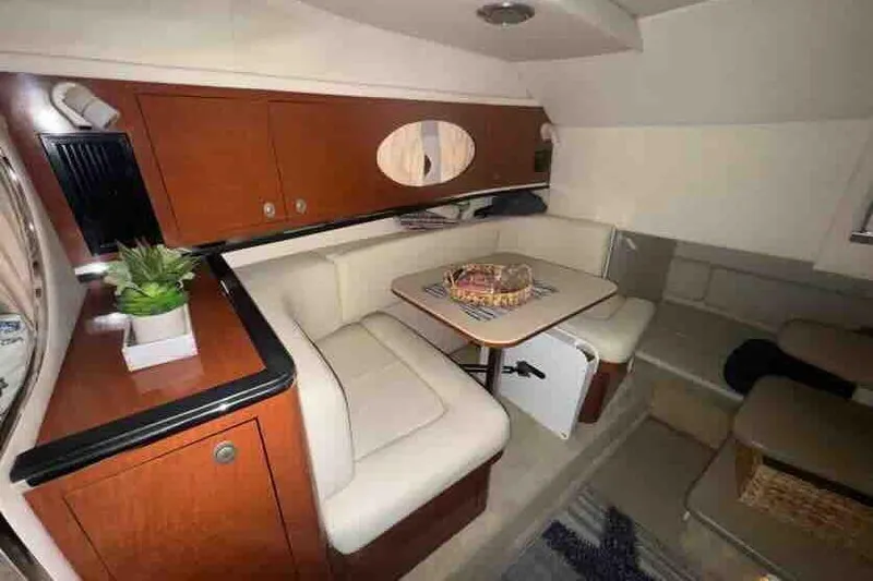 Slide: The Image of 2005 Sea Ray 290 Amberjack cabin interior with seating and table. - 24