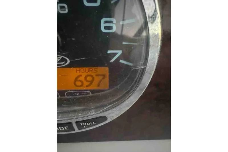 Slide: The Image of Close-up of 2005 Sea Ray 290 Amberjack gauge showing 697 hours. - 25