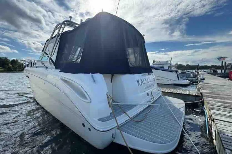 Slide: The Image of 2005 Sea Ray 290 Amberjack docked at marina under a partly cloudy sky. - 3