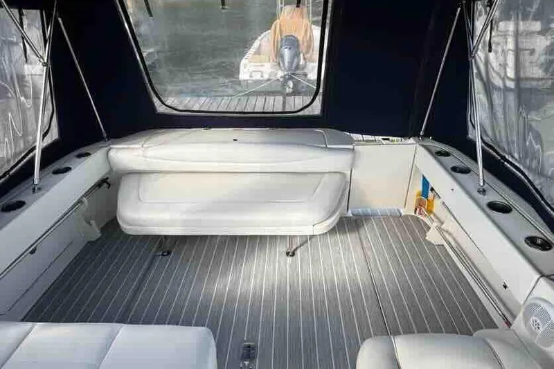 Slide: The Image of 2005 Sea Ray 290 Amberjack interior with white seating and striped flooring. - 9