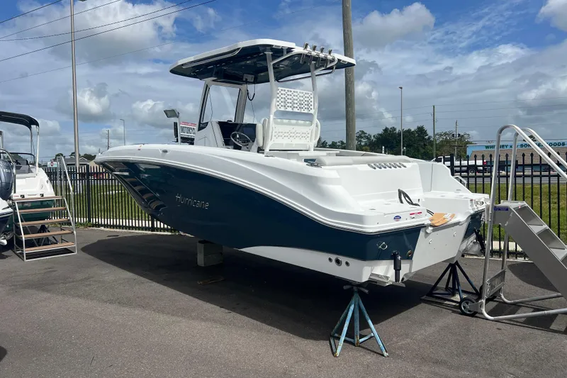 Slide: The Image of 2025 Hurricane Center Console 24 OB boat displayed outdoors on a sunny day. - 1