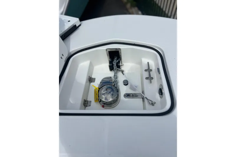 Slide: The Image of 2025 Hurricane Center Console 24 OB anchor compartment with chain and cleat. - 15