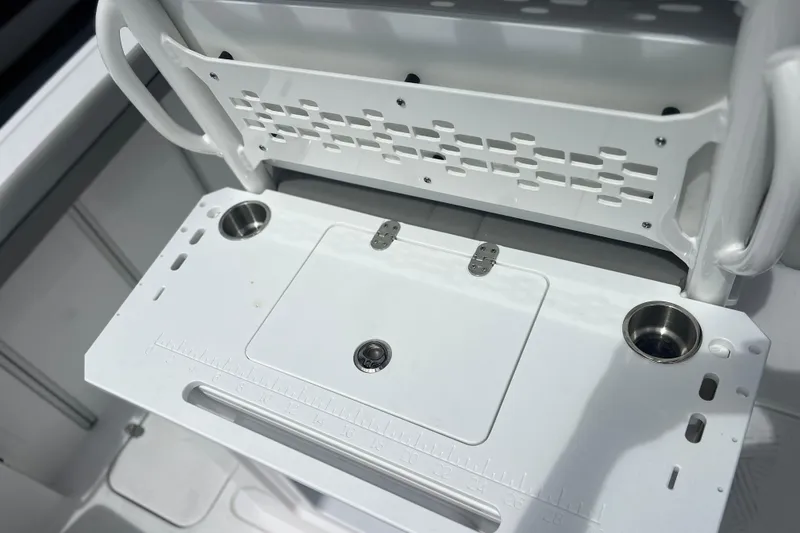 Slide: The Image of 2025 Hurricane Center Console 24 OB boat interior with cup holders and storage compartment. - 17