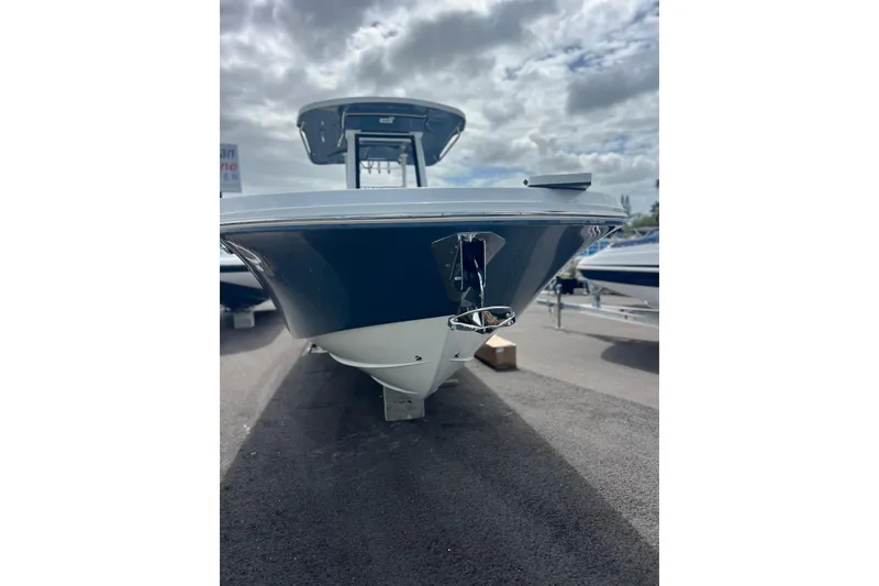 Slide: The Image of 2025 Hurricane Center Console 24 OB boat, sleek design under cloudy sky. - 4