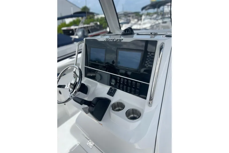 Slide: The Image of 2025 Hurricane Center Console 24 OB boat dashboard with steering wheel and control panel. - 7