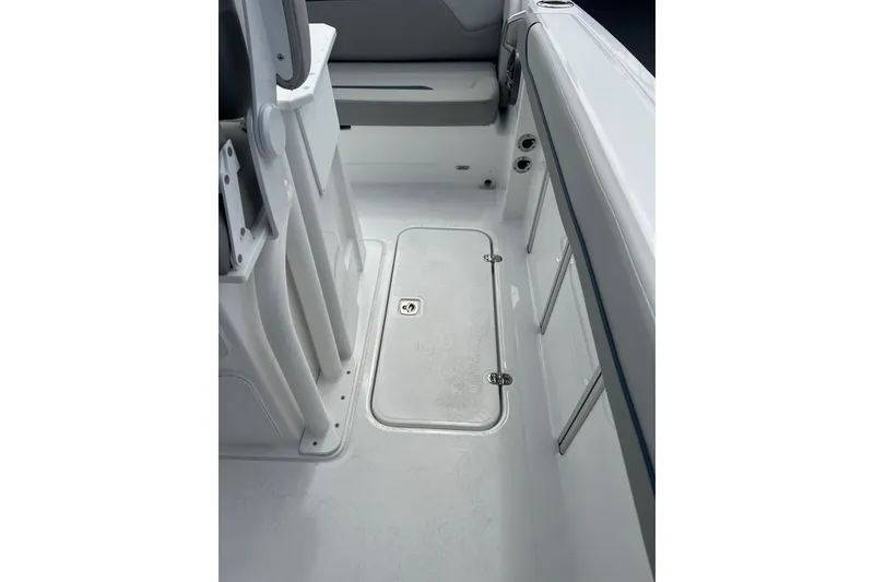 Slide: The Image of 2025 Hurricane Center Console 24 OB interior, featuring sleek white deck and seating. - 9
