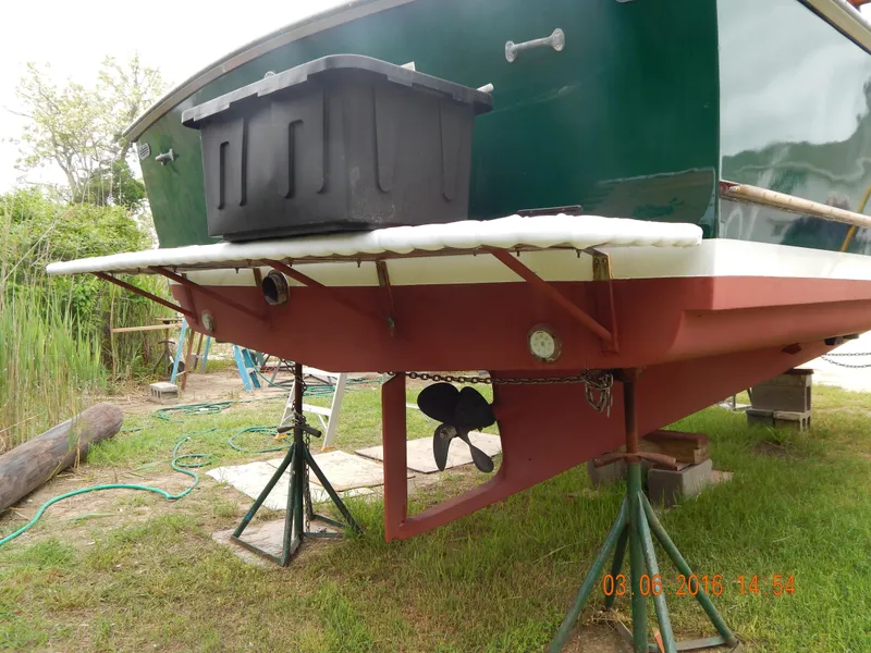 Slide: The Image of 1997 Webbers Cove PB 26 boat on stands, showing propeller and hull details. - 3