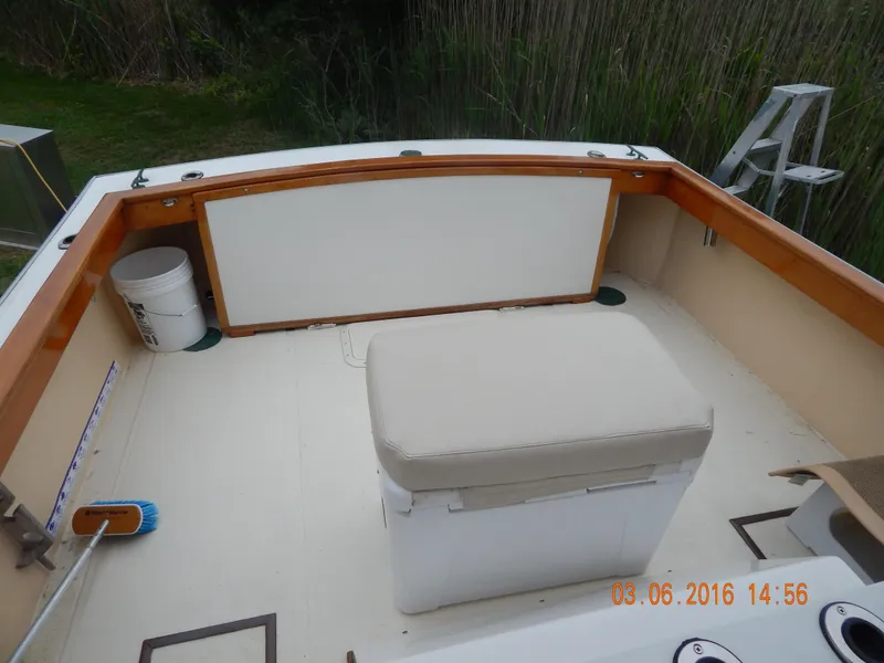 Slide: The Image of 1997 Webbers Cove PB 26 boat deck with seating and cleaning supplies. - 4