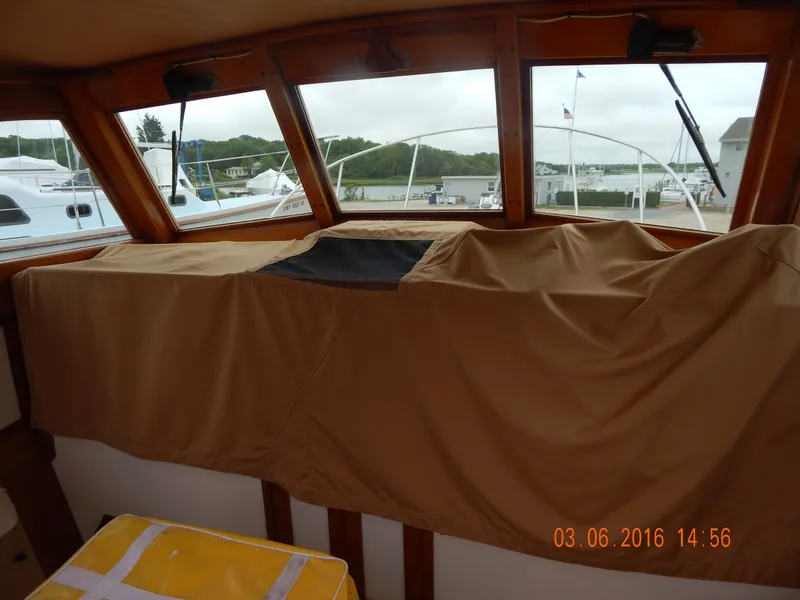 Slide: The Image of Interior view of a 1997 Webbers Cove PB 26 boat with covered dashboard. - 6