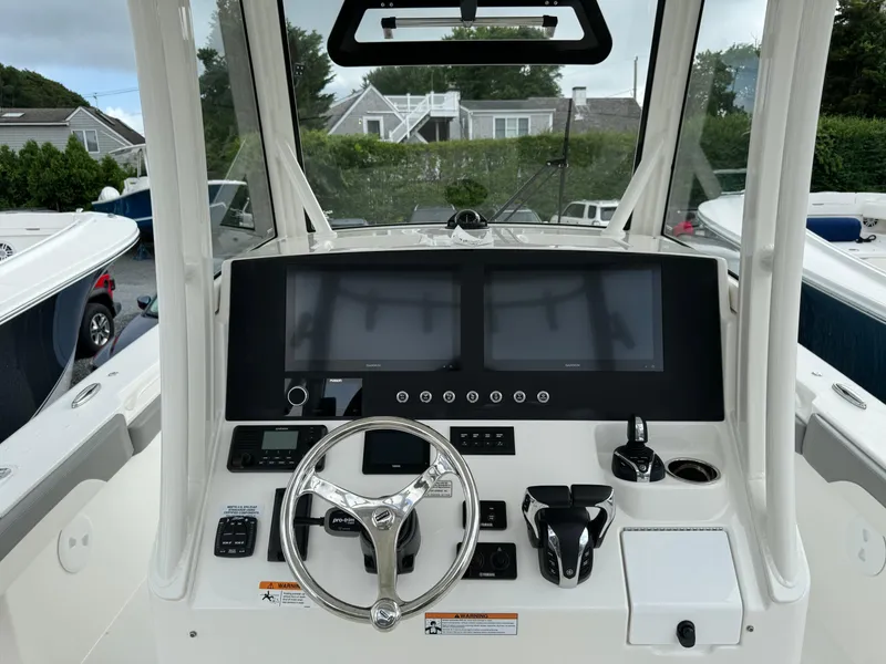 Slide: The Image of 2024 Regulator 30XO boat dashboard with dual screens and steering wheel. - 11