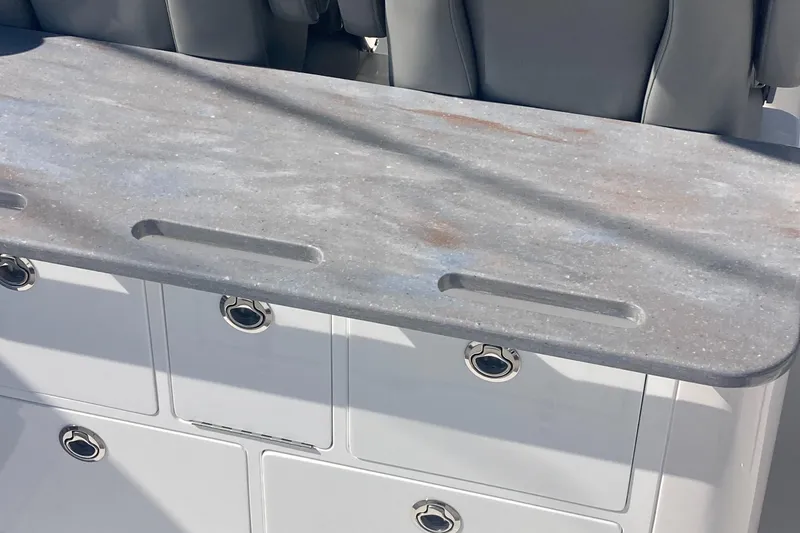 Slide: The Image of 2024 Regulator 30XO boat interior with sleek countertop and storage compartments. - 15