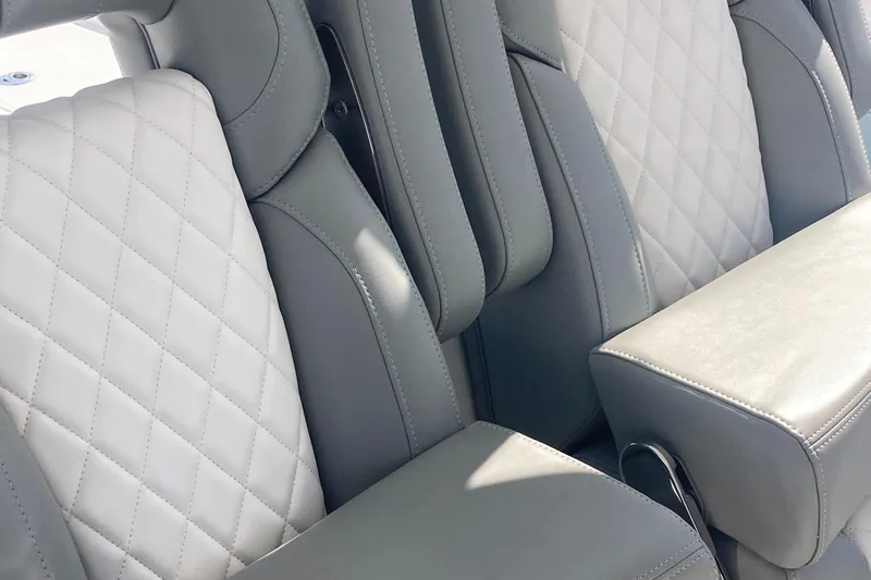 Slide: The Image of 2024 Regulator 30XO boat interior with gray and white quilted seating. - 16