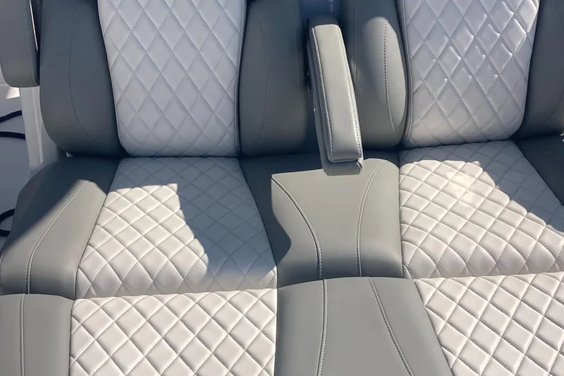 Slide: The Image of 2024 Regulator 30XO boat seats with quilted gray and white upholstery. - 17