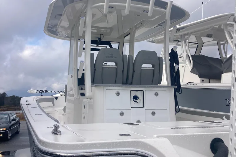 Slide: The Image of 2024 Regulator 30XO boat with dual seats and center console under cloudy sky. - 7