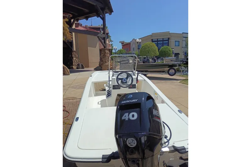 Slide: The Image of 2026 Mako Pro Skiff 13 CC boat with Mercury 40 engine in outdoor setting. - 44