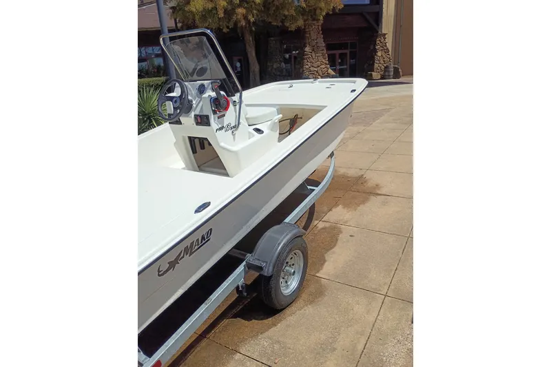 Slide: The Image of 2026 Mako Pro Skiff 13 CC boat on trailer, parked outdoors. - 46
