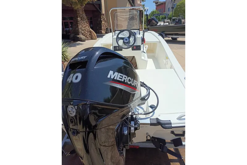 Slide: The Image of 2026 Mako Pro Skiff 13 CC with Mercury 40 HP engine, parked outdoors. - 48