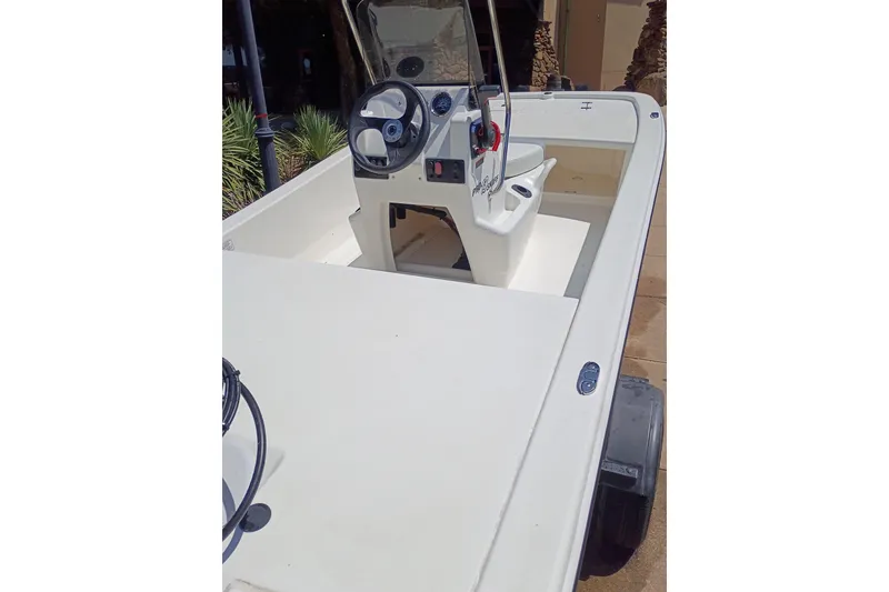 Slide: The Image of 2026 Mako Pro Skiff 13 CC boat interior with steering console and seating. - 52