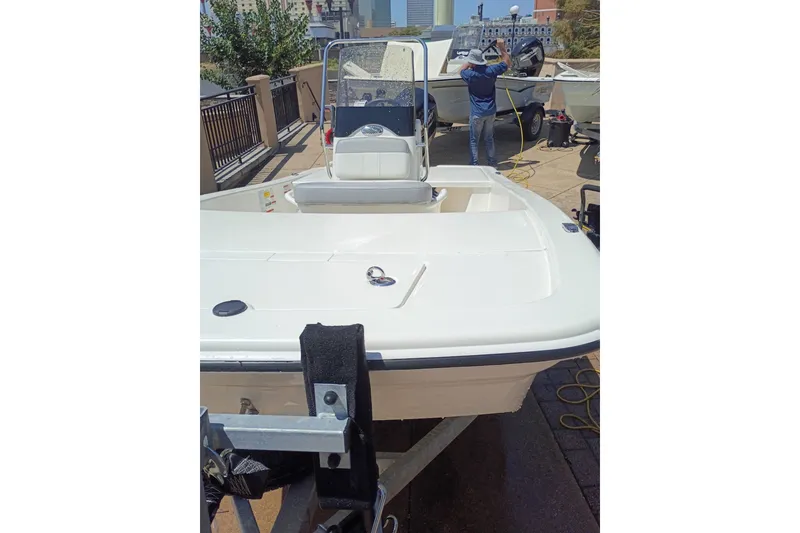 Slide: The Image of 2026 Mako Pro Skiff 13 CC boat on trailer, outdoor setting. - 54