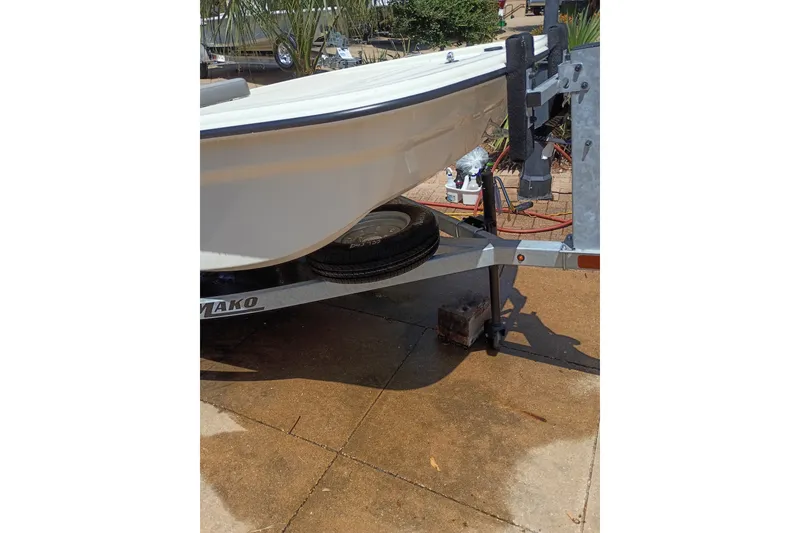 Slide: The Image of 2026 Mako Pro Skiff 13 CC boat on trailer, parked on concrete surface. - 51