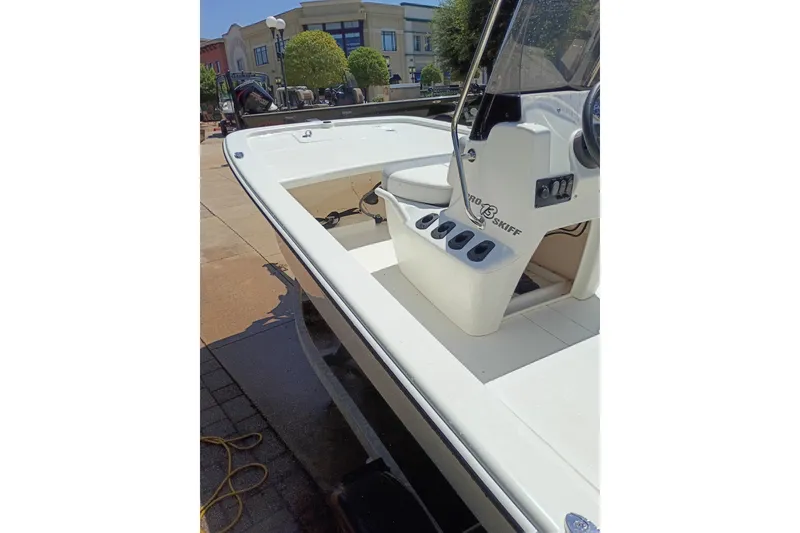 Slide: The Image of 2026 Mako Pro Skiff 13 CC boat, white deck, console view, outdoor setting. - 45