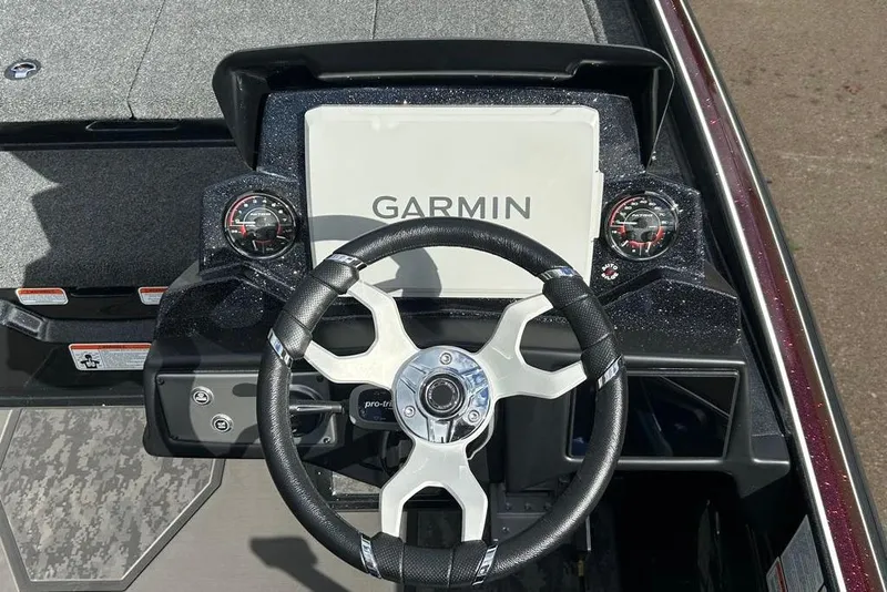 Slide: The Image of 2026 Nitro Z21 XL Pro boat dashboard with Garmin display and steering wheel. - 82