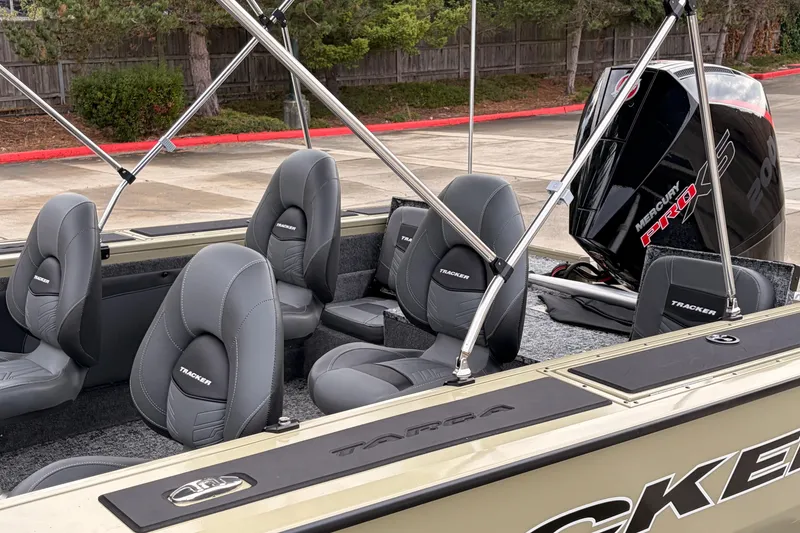 Slide: The Image of 2026 Tracker Targa V-19 Combo boat interior with open storage compartment and carpeted flooring. - 16