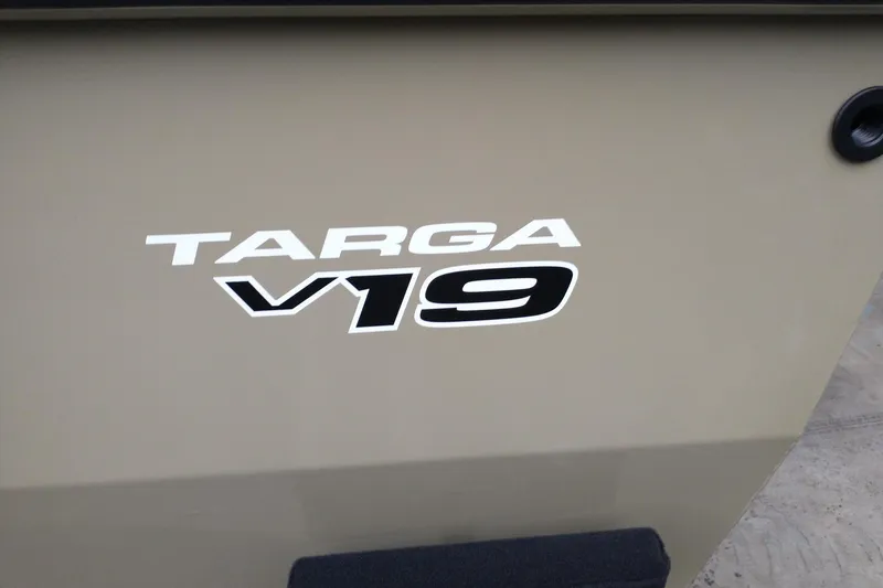 Slide: The Image of 2026 Tracker Targa V-19 Combo boat logo on beige surface. - 2
