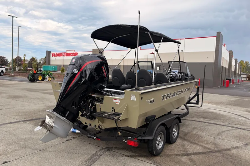 Slide: The Image of 2026 Tracker Targa V-19 Combo boat with outboard motor in parking lot. - 6