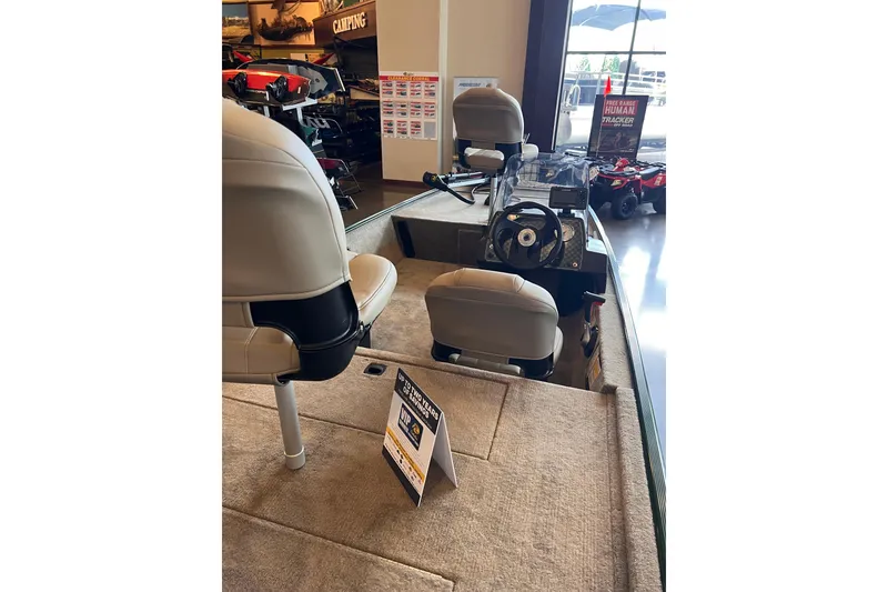 Slide: The Image of 2026 Tracker Bass Tracker Classic Limited boat interior with seating and steering console. - 2