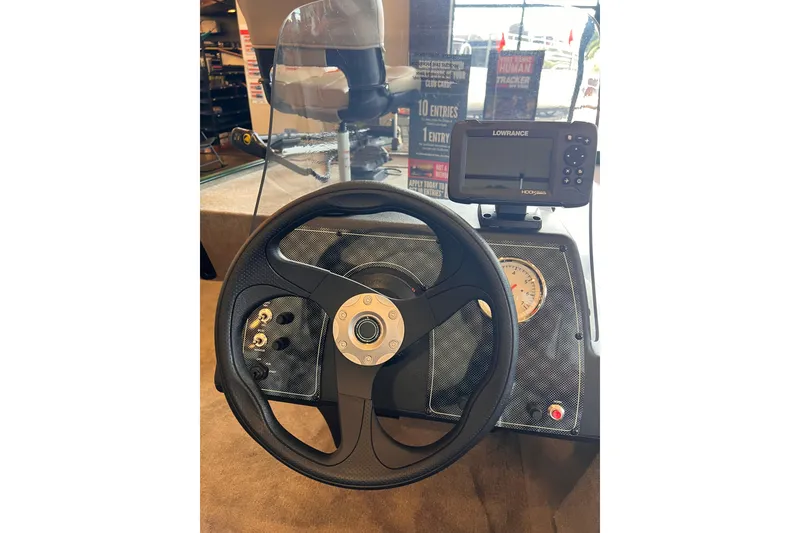 Slide: The Image of 2026 Tracker Bass Tracker Classic Limited dashboard with steering wheel and Lowrance fishfinder. - 3