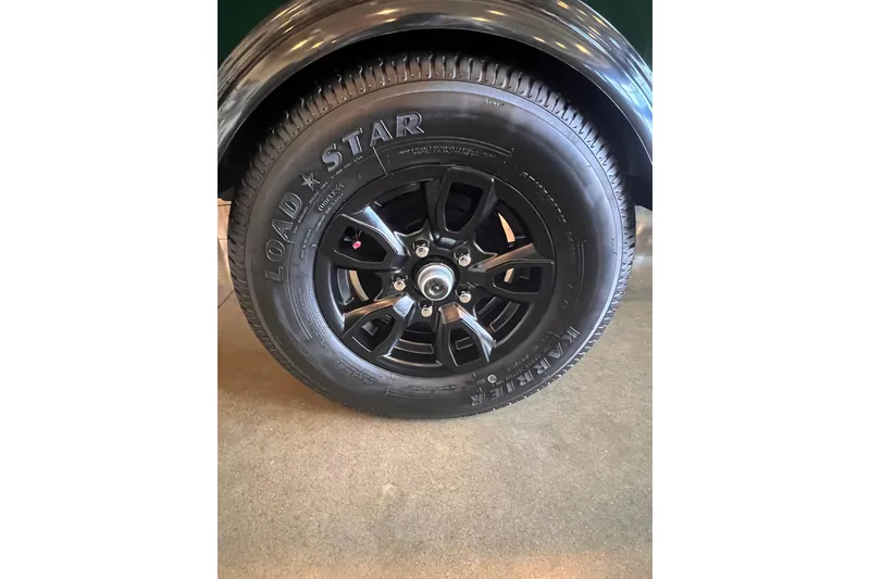 Slide: The Image of 2026 Tracker Bass Tracker Classic Limited trailer tire with black alloy wheel. - 5