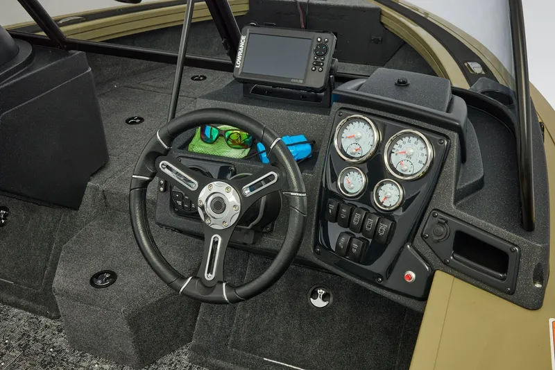 Slide: The Image of 2026 Tracker Targa V-19 Combo boat storage compartment with orange case inside. - 23