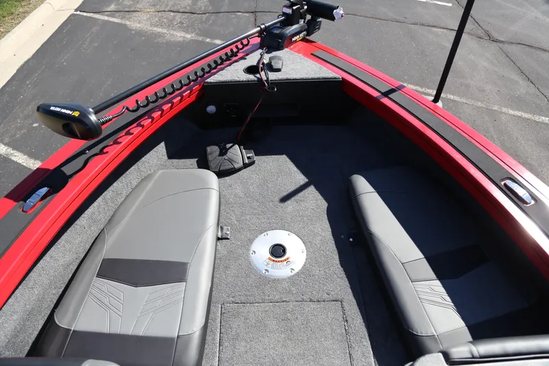 Slide: The Image of 2026 Tracker Targa V-19 Combo boat interior with four gray seats and red accents. - 3