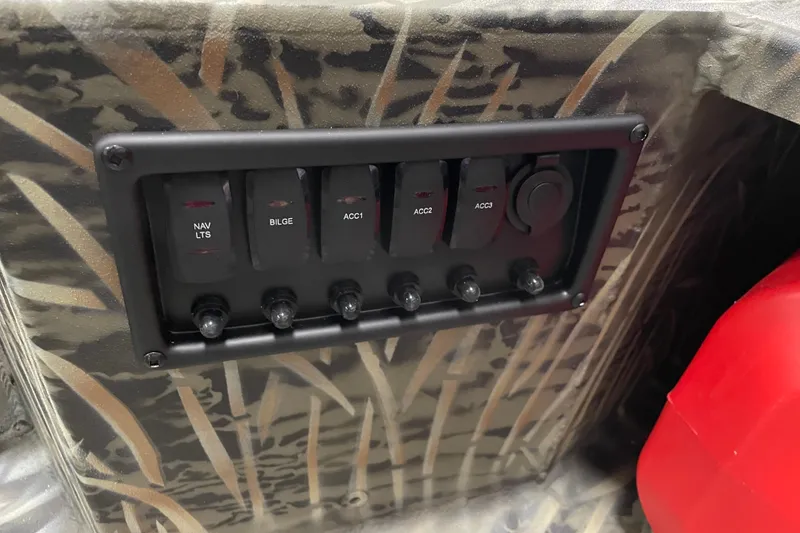 Slide: The Image of Control panel of 2026 Tracker Grizzly 1650 T Prairie Wings Edition with camo design. - 10