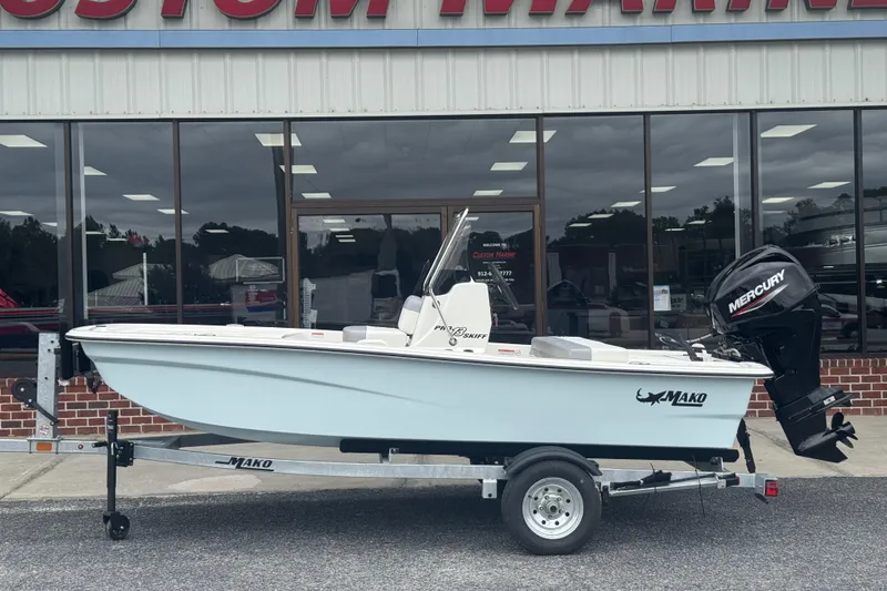 The Image of 2026 Mako Pro Skiff 13 CC boat with Mercury engine on trailer outside dealership. - 43