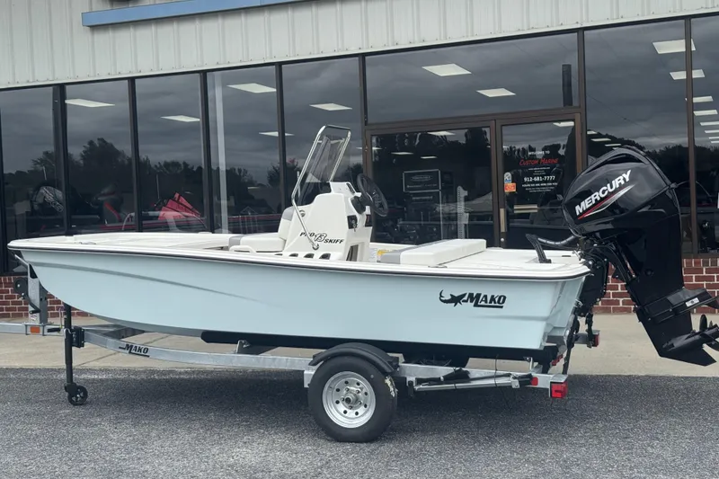 Slide: The Image of 2026 Mako Pro Skiff 13 CC boat with Mercury engine on trailer outside dealership. - 44