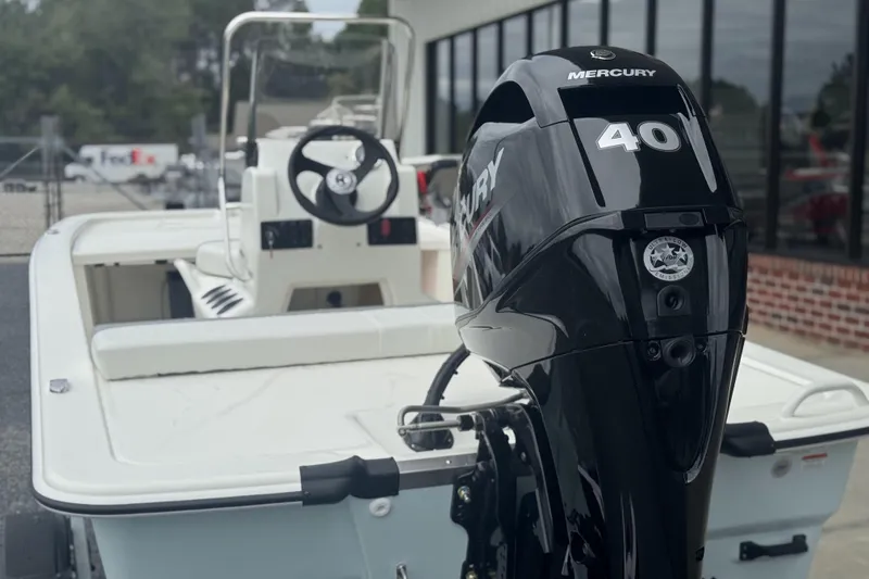 Slide: The Image of 2026 Mako Pro Skiff 13 CC with Mercury 40 outboard motor, parked outdoors. - 47
