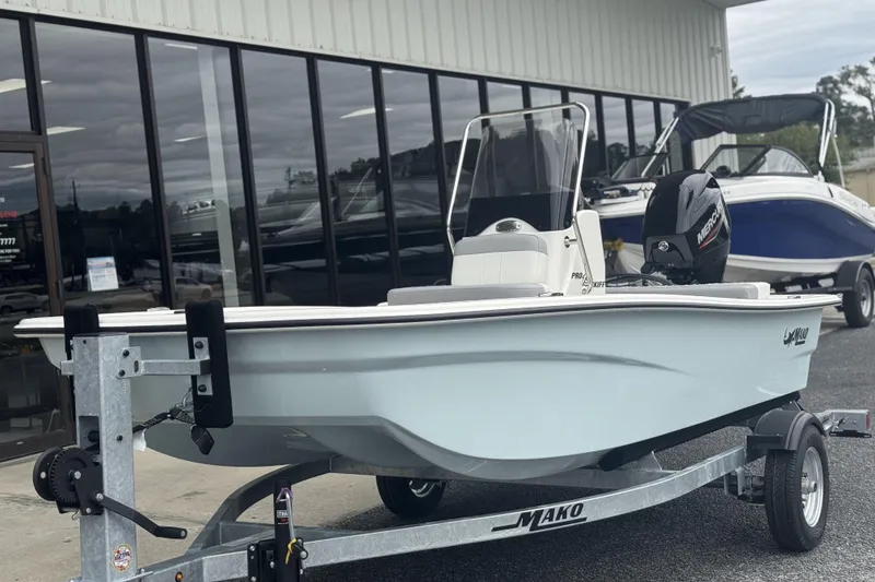 Slide: The Image of 2026 Mako Pro Skiff 13 CC boat on trailer outside dealership. - 55