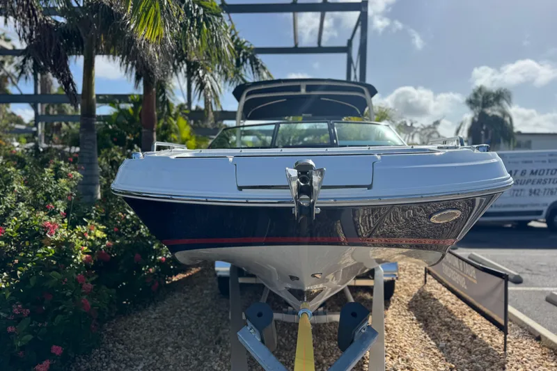 Slide: The Image of 2026 Four Winns HD8 OB boat displayed outdoors with palm trees in the background. - 12